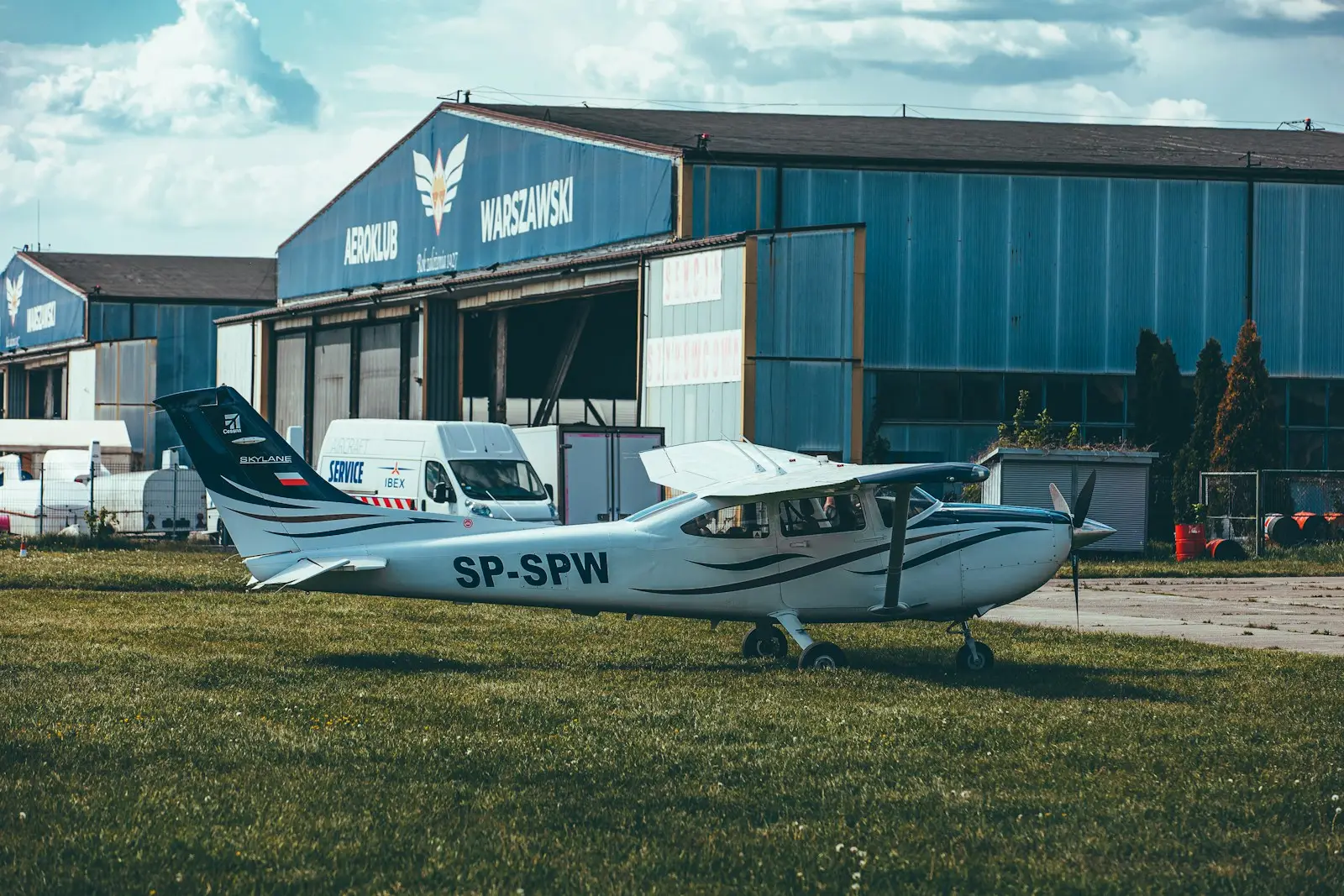 a small airplane parked in front of a hangar